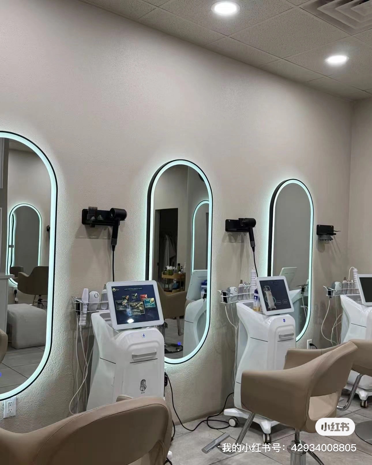 Row of oval backlit mirrors and styling stations with scalp-analysis machines at Briar Beauty Spa